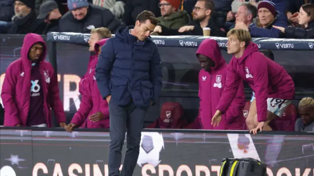 Scott Parker looking dejected in front of bench with Burnley substitutes in purple coats