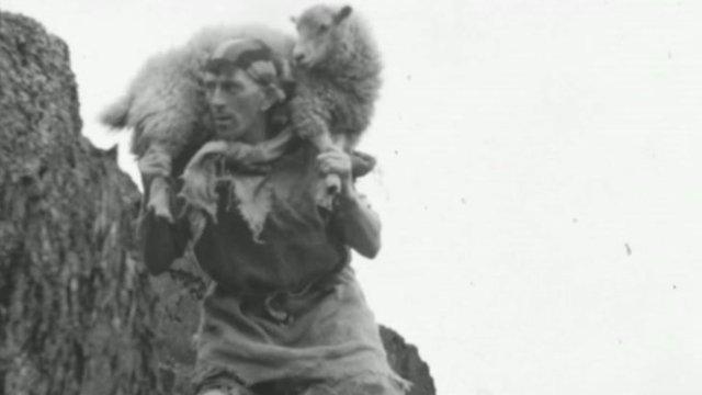An image showing a man holding a sheep in a historical film witin the BFI archive