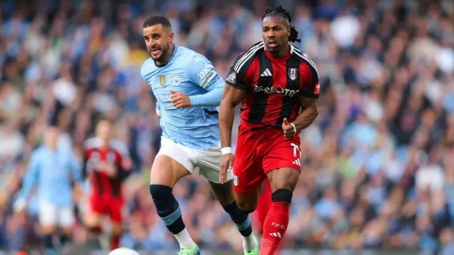 Adama Traore and Kyle Walker battle for possession 