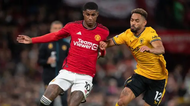 Marcus Rashford and Matheus Cunha battle for the ball in a game between Manchester United and Wolves at Old Trafford