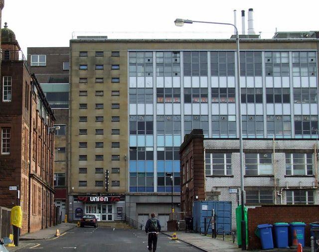 Strathclyde Union, viewed from Martha Street. It is an aging 10-storey building with a sign saying "union" above the ground floor entrance. 