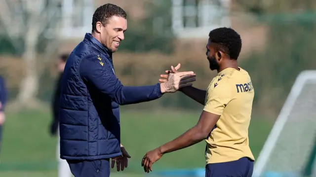 Valerien Ismael greets Emmanuel Dennis on the training ground