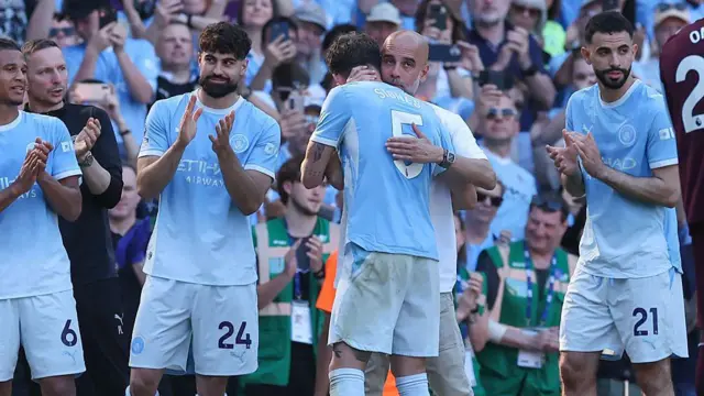 Josep Guardiola hugs John Stones as he is substituted in his last game