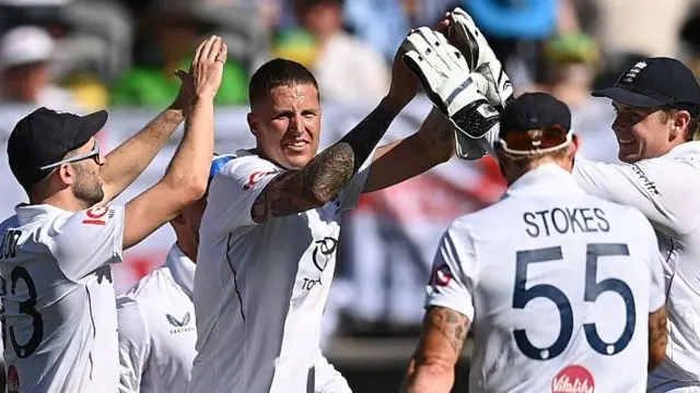 Brydon Carse high-fives team-mates