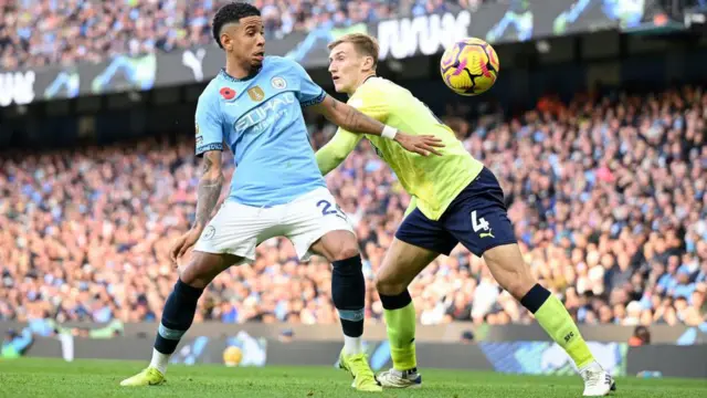 Savinho of Manchester City looks to the ball whilst under pressure from Flynn Downes of Southampton during the Premier League match between Manchester City FC and Southampton FC at Etihad Stadium