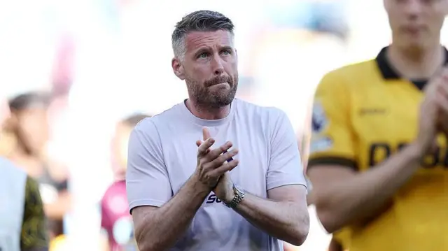 Rob Edwards, Manager of Wolverhampton Wanderers, applauds the fans