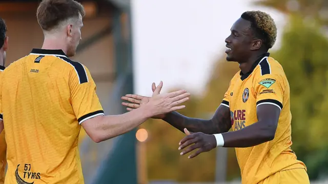 Shaquille Gwengwe celebrates scoring for Newport County against Newport City