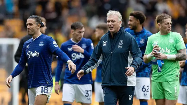 Jack Grealish, David Moyes and Jordan Pickford after victory for Everton