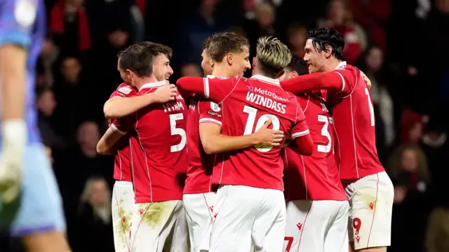 Wrexham players celebrate scoring their second goal against Bristol City