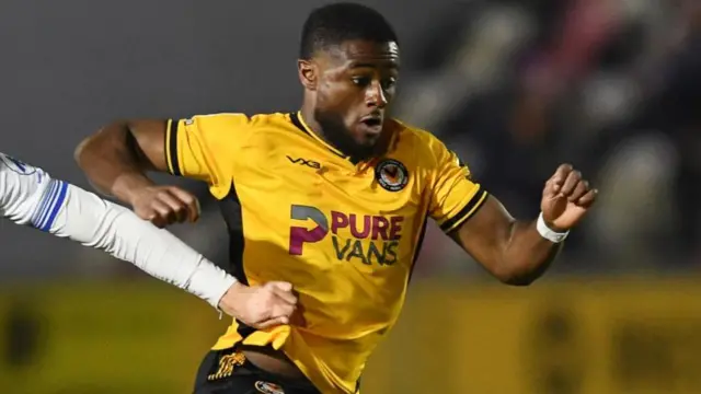 Newport County's David Ajiboye runs away from a defender with the ball