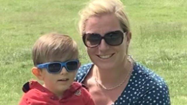 William in a red short sleeved shirt with mum Alice in a blue and white dress