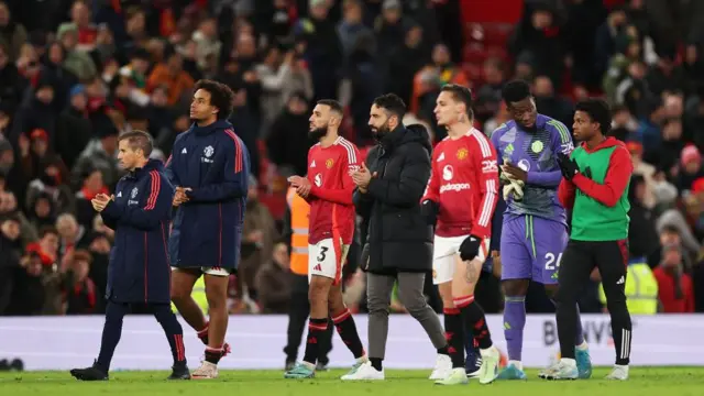 Ruben Amorim, Manager of Manchester United, Joshua Zirkzee and Noussair Mazraoui applaud the fans at the end of the Premier League match between Manchester United FC and Newcastle United FC at Old Trafford on December 30, 2024