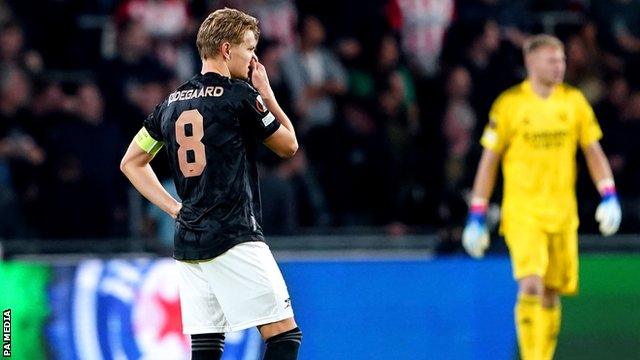 Arsenal's players react after conceding a goal against PSV Eindhoven in the Europa League