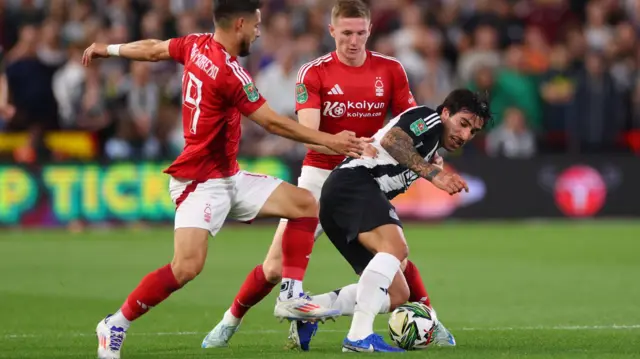 Sandro Tonali tackled by Nottingham Forest players