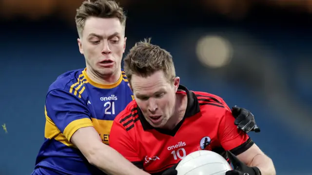 Naomh Padraig's Padraig O Loideain and Andrew McCarron of Carraroe battle for the ball 