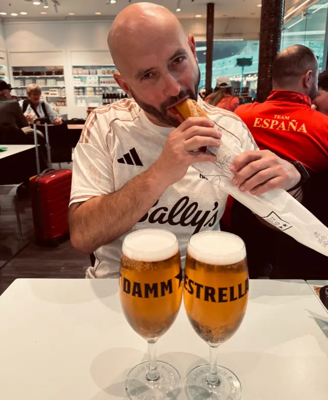 A man eating a sandwich in an airport 