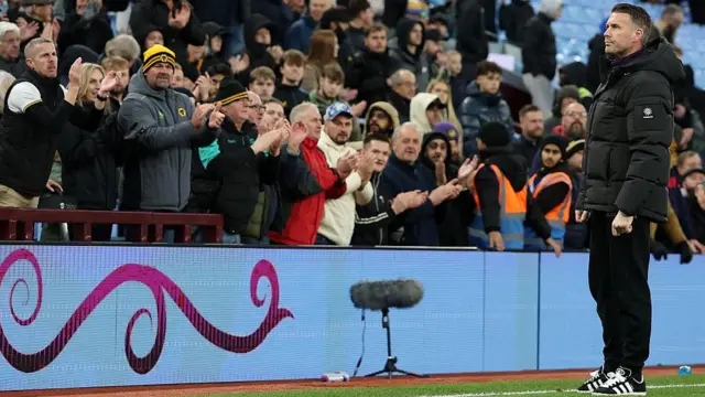 Rob Edwards, Manager of Wolverhampton Wanderers, applauds the fans