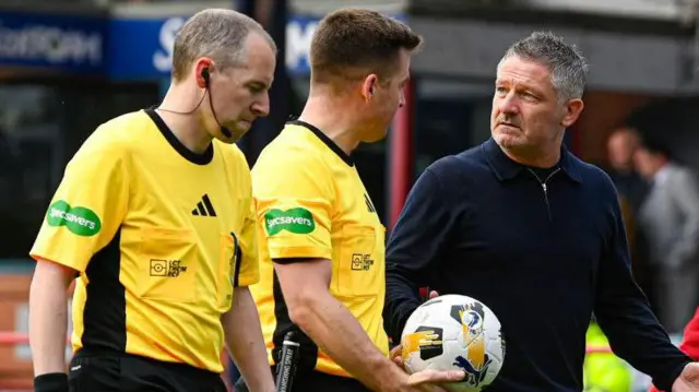 Dundee manager Tony Docherty, right, talks to officials