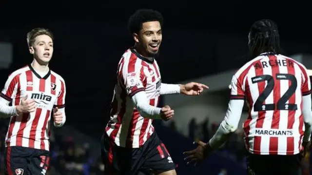 Ashley Hay of Cheltenham Town celebrates with teammate Ethon Archer after scoring his team's first goal during the Sky Bet League Two match between AFC Wimbledon and Cheltenham Town