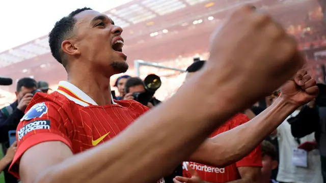 Trent Alexander-Arnold celebrates in from of Liverpool's fans after the Reds won the Premier League title