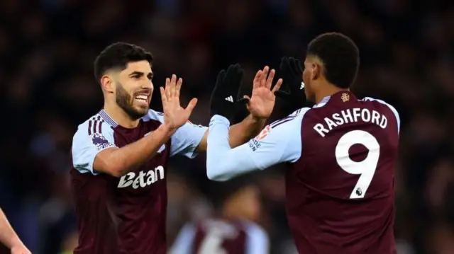 Marco Asensio and Marcus Rashford celebrate