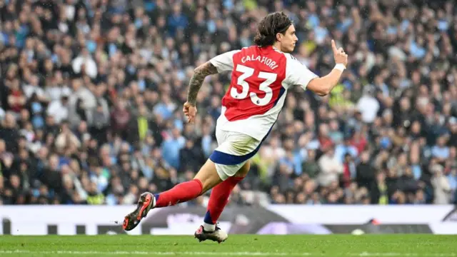 Riccardo Calafiori of Arsenal celebrates scoring his team's first goal during the Premier League match between Manchester City FC and Arsenal FC at Etihad Stadium