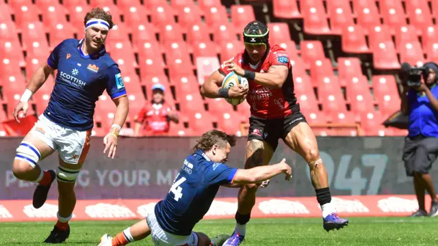 Darcy Graham attempts a tackle during Edinburgh's loss to Lions