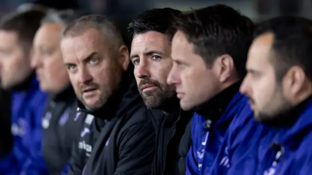 Alan Sheehan with members of Swansea's staff at Watford in midweek 