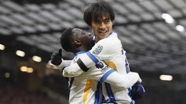 Yankuba Minteh and Kaoru Mitoma hug and celebrate goal