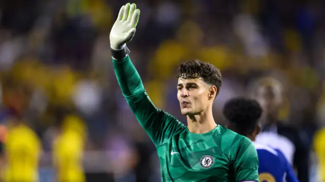 Kepa Arrizabalaga waves to Chelsea supporters after a match
