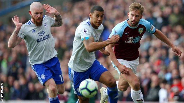 Burnely's Charlie Taylor is challenged by two Cardiff players