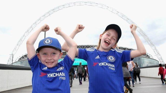 Chelsea fans pose in front of Wembley before the FA Women's Cup final