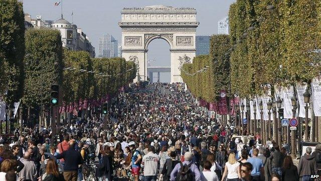 Crowds of pedestrians and cyclists on the Champs-Elysees