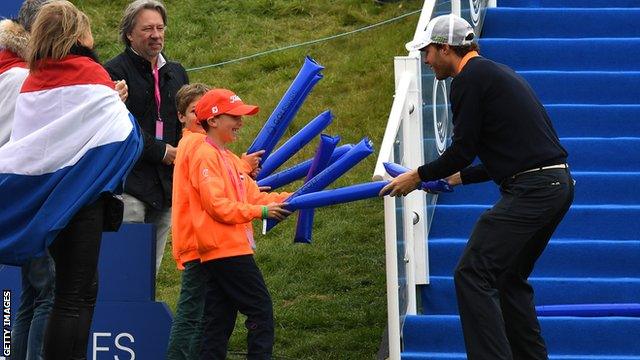 Reinier Saxton of Netherlands jokes with fans on the first tee