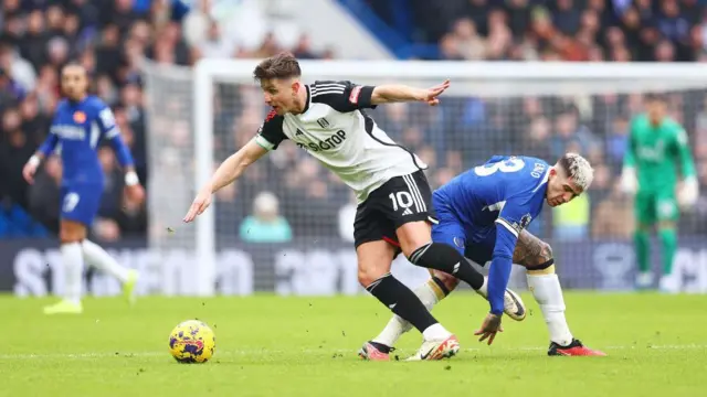 Tom Cairney of Fulham is challenged by Enzo Fernandez of Chelsea