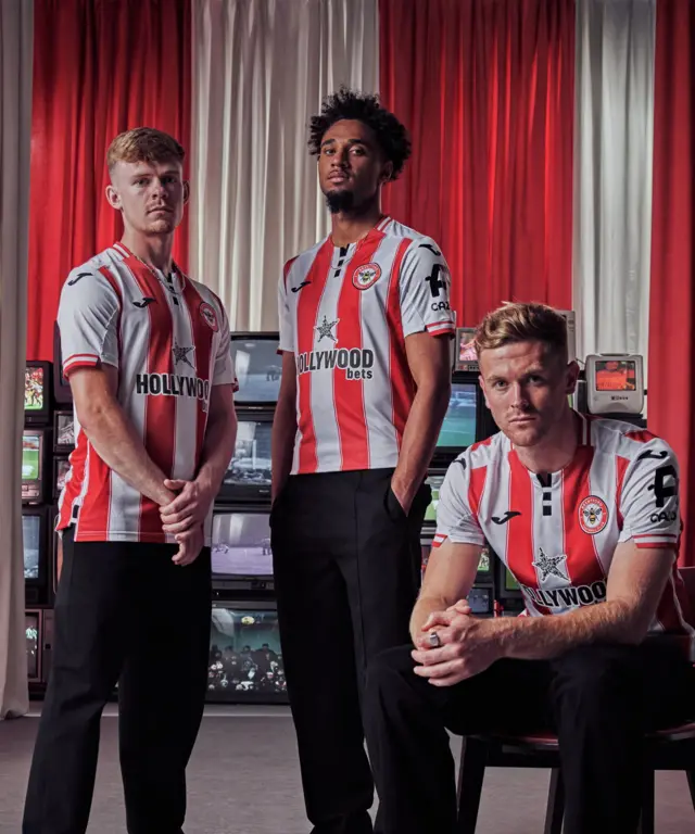 Keane Lewis-Potter, Kevin Schade and Nathan Collins model Brentford's new home shirt
