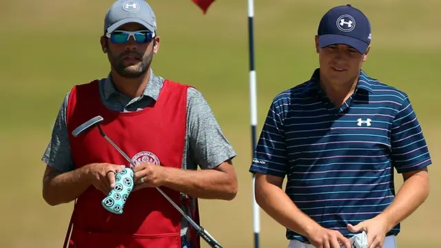 Jordan Spieth walks with his caddie