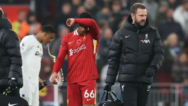 Trent Alexander-Arnold walks off with physio after picking up injury during Aston Villa match