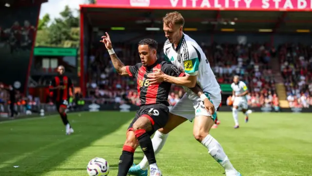 Justin Kluivert of Bournemouth holds off Dan Burn of Newcastle United during the Premier League match between AFC Bournemouth and Newcastle United FC at Vitality Stadium