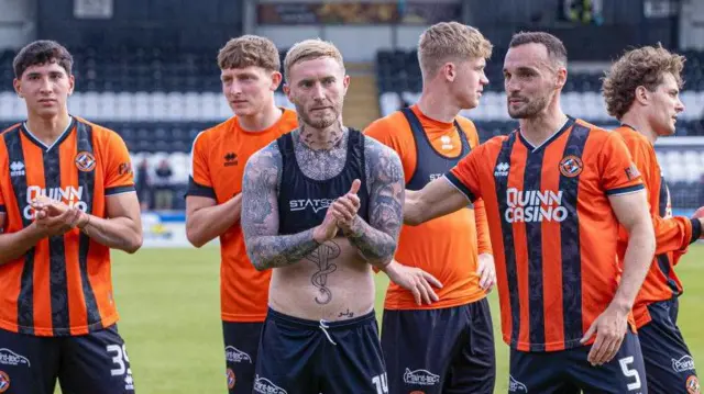 Dundee United players applaud visiting fans in Paisley