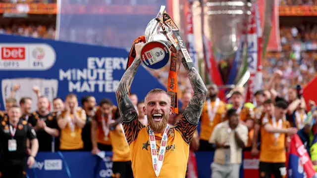 Hull City player Oliver McBurnie celebrates with the EFL Sky Bet Championship Play off Final trophy.
