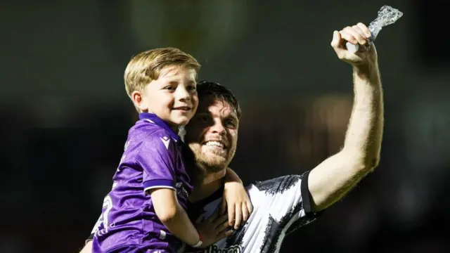 Marcus Fraser celebrates the play-off victory with his son