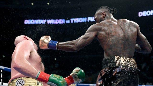 Deontay Wilder knocking down Tyson Fury