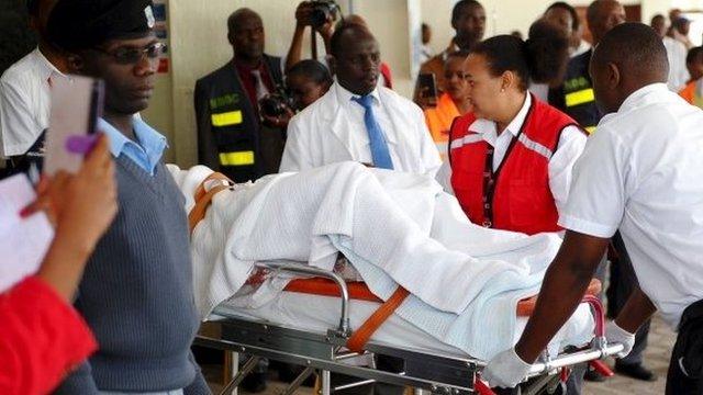 A man injured during an attack on a residential complex in Soko Mbuzi village of Mandera town at the Kenya-Somalia border is wheeled on a stretcher