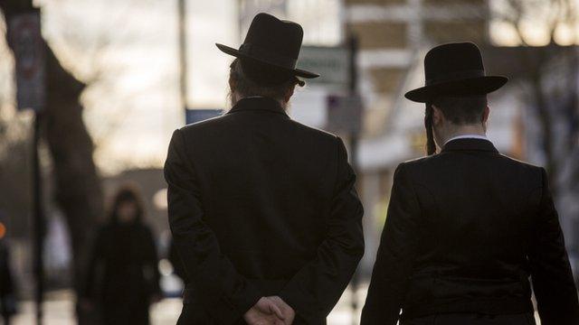 Charedi men walking in Stamford Hill, London