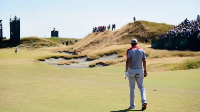 Dustin Johnson walks along the fairway