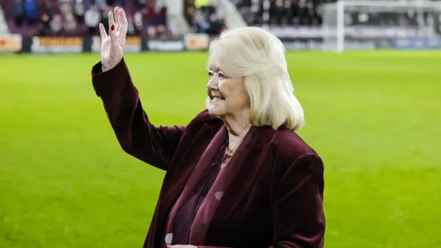 Ann Budge waves to the crowd