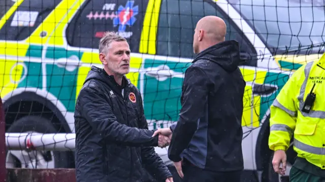 Stenhousemuir Manager Gary Naysmith (L) and Motherwell Manager Jens Berthel Askou (R) shake hands at full time during a Premier Sports Cup group stage match between Stenhousemuir and Motherwell 