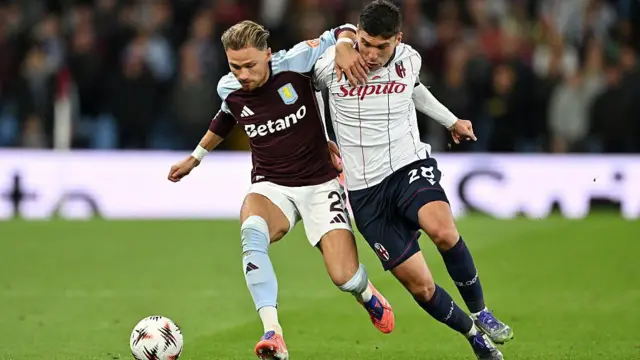  Matty Cash is challenged by Nicolo Cambiaghi