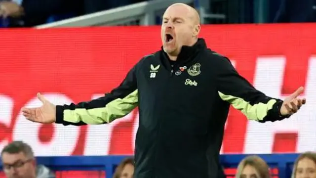 Sean Dyche with his arms outstretched